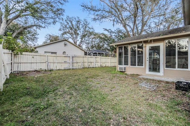 view of yard featuring a wall mounted air conditioner