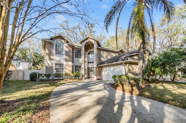 view of property featuring a garage and a front lawn