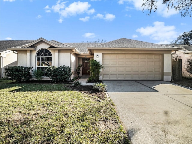 single story home featuring a garage and a front yard