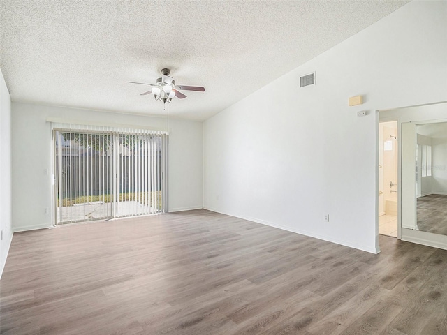 spare room with hardwood / wood-style flooring, ceiling fan, and a textured ceiling