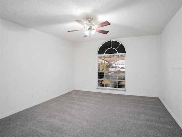 carpeted spare room with a textured ceiling and ceiling fan