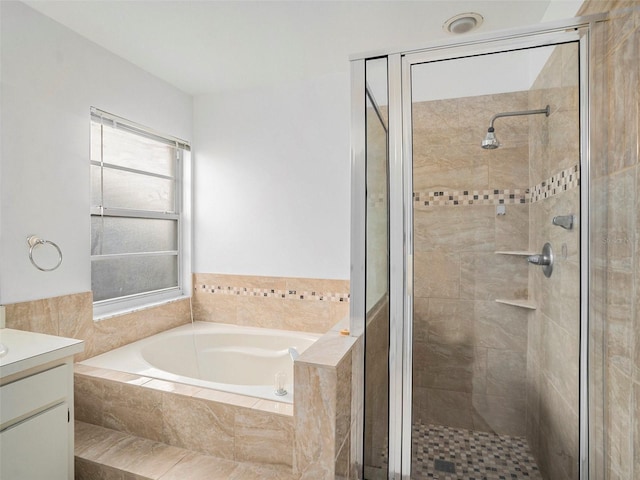 bathroom featuring vanity and independent shower and bath