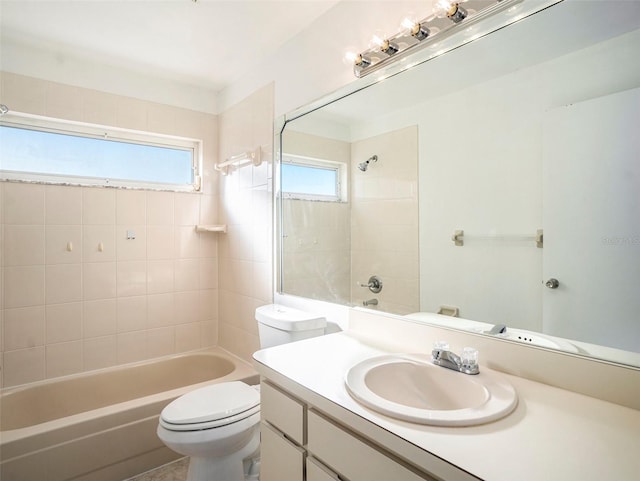 full bathroom featuring vanity, toilet, and tiled shower / bath