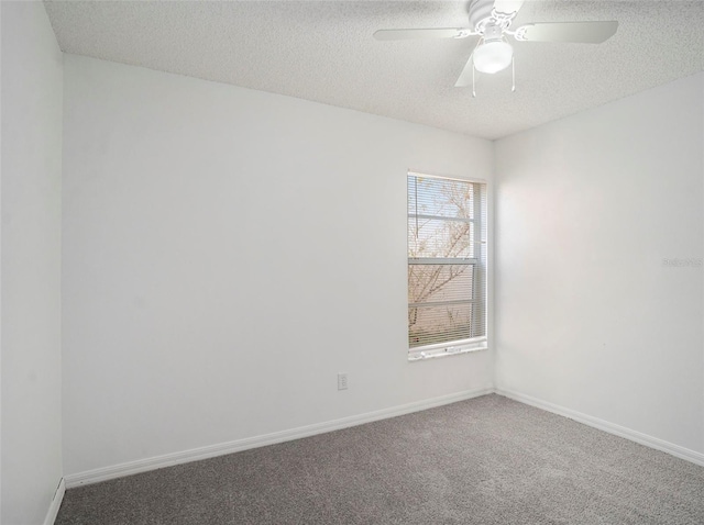 carpeted empty room with ceiling fan and a textured ceiling