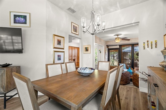 dining space featuring a chandelier and light hardwood / wood-style flooring