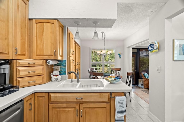 kitchen featuring sink, a textured ceiling, light tile patterned flooring, decorative light fixtures, and stainless steel dishwasher