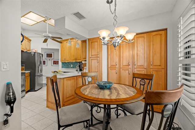 kitchen featuring stainless steel refrigerator with ice dispenser, decorative light fixtures, light tile patterned floors, range with electric cooktop, and ceiling fan with notable chandelier