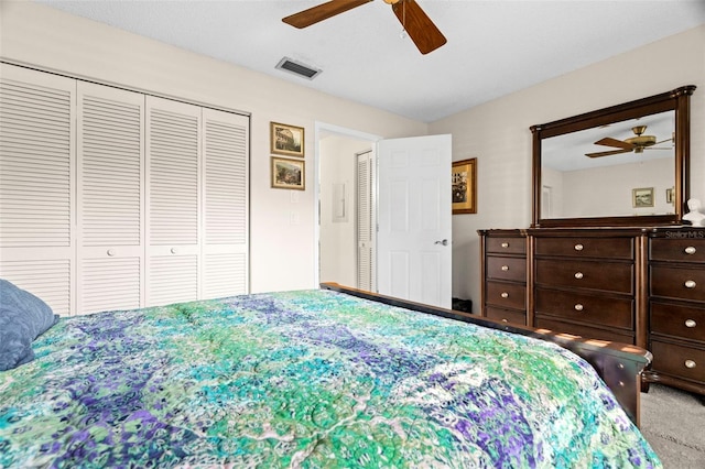 bedroom featuring a closet, ceiling fan, and carpet