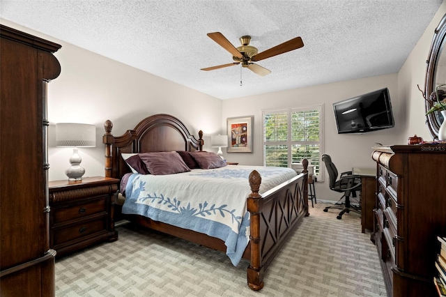 carpeted bedroom with ceiling fan and a textured ceiling