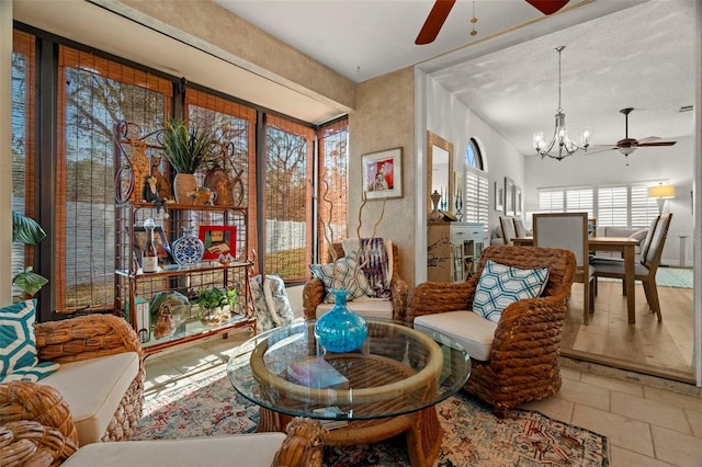 sunroom / solarium with ceiling fan with notable chandelier