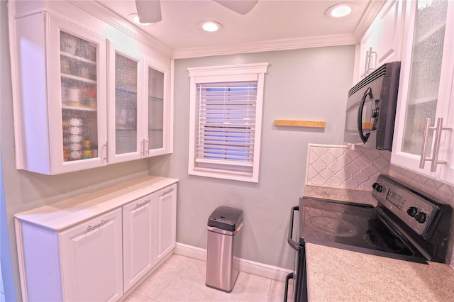 interior space featuring tasteful backsplash, stainless steel electric range, light tile patterned floors, ornamental molding, and white cabinets