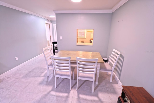 dining area with crown molding and light tile patterned floors