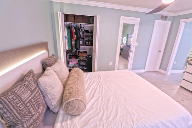 bedroom featuring crown molding, a closet, and light tile patterned floors