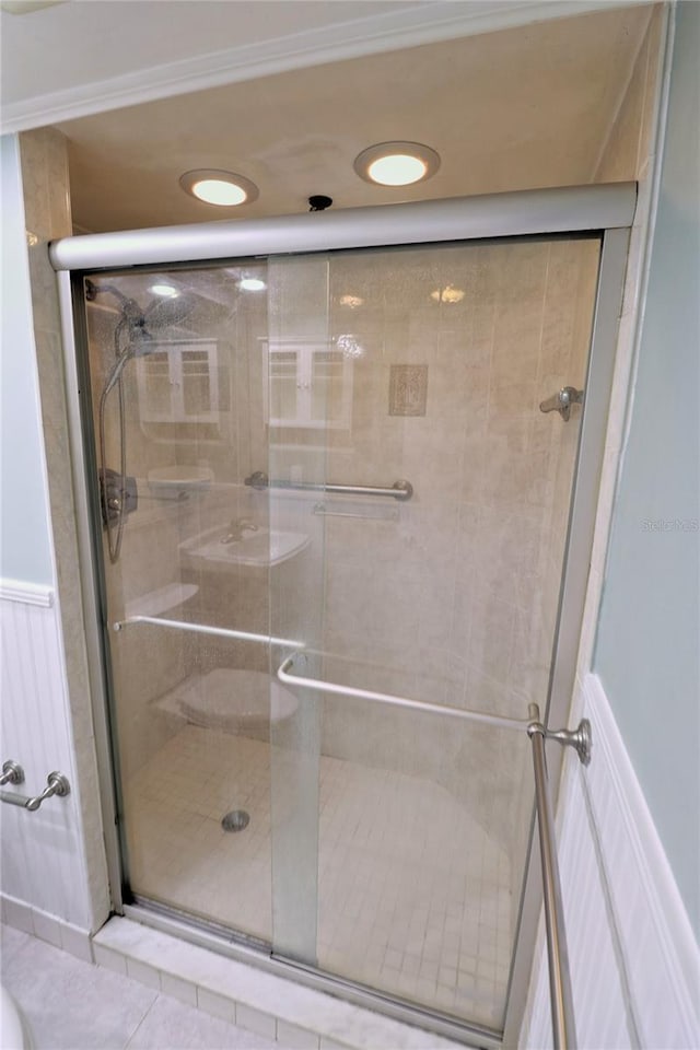 bathroom featuring tile patterned flooring and an enclosed shower