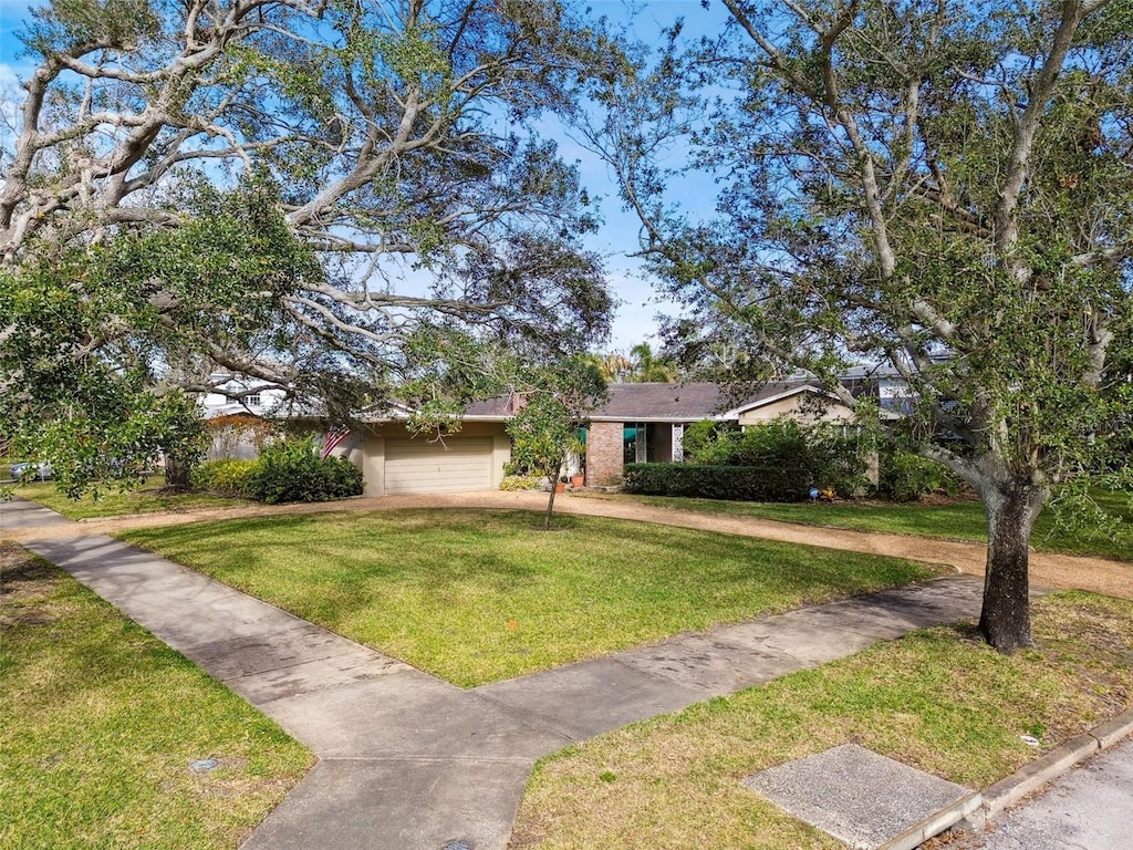 view of front of property featuring a garage and a front lawn