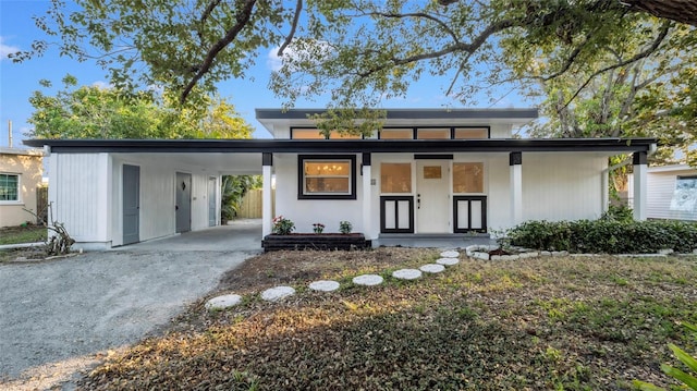 contemporary house featuring a carport