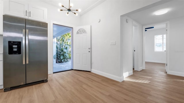 entryway featuring an inviting chandelier and light wood-type flooring