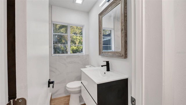 bathroom featuring hardwood / wood-style flooring, vanity, and toilet