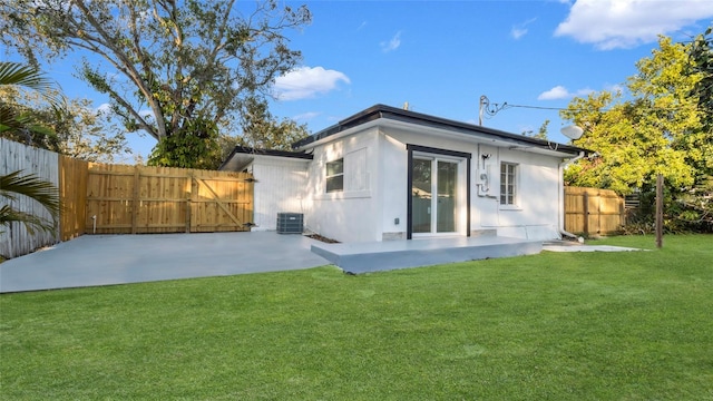 back of property featuring a patio, a yard, and central AC unit