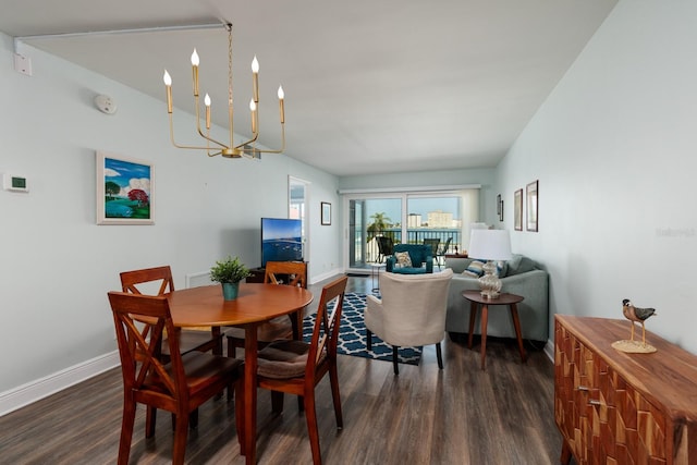 dining area with a notable chandelier and dark hardwood / wood-style flooring