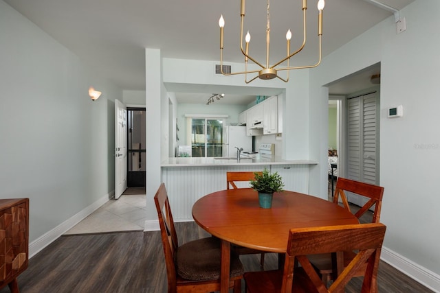 dining room featuring wood-type flooring and a notable chandelier