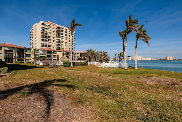 view of property's community featuring a water view and a lawn