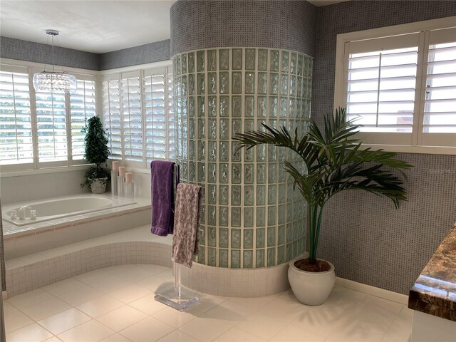 bathroom with tile patterned floors and tiled bath