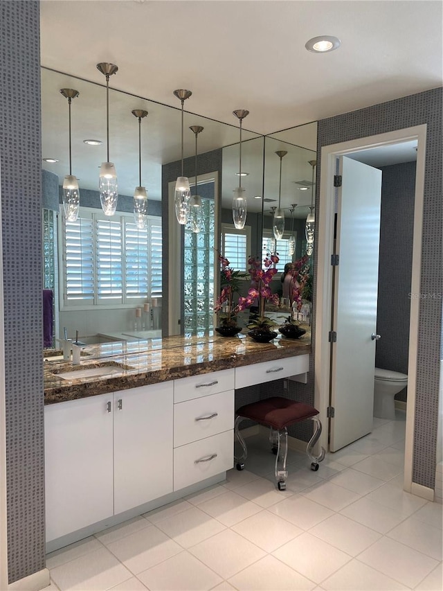 bathroom featuring vanity, toilet, and tile patterned flooring