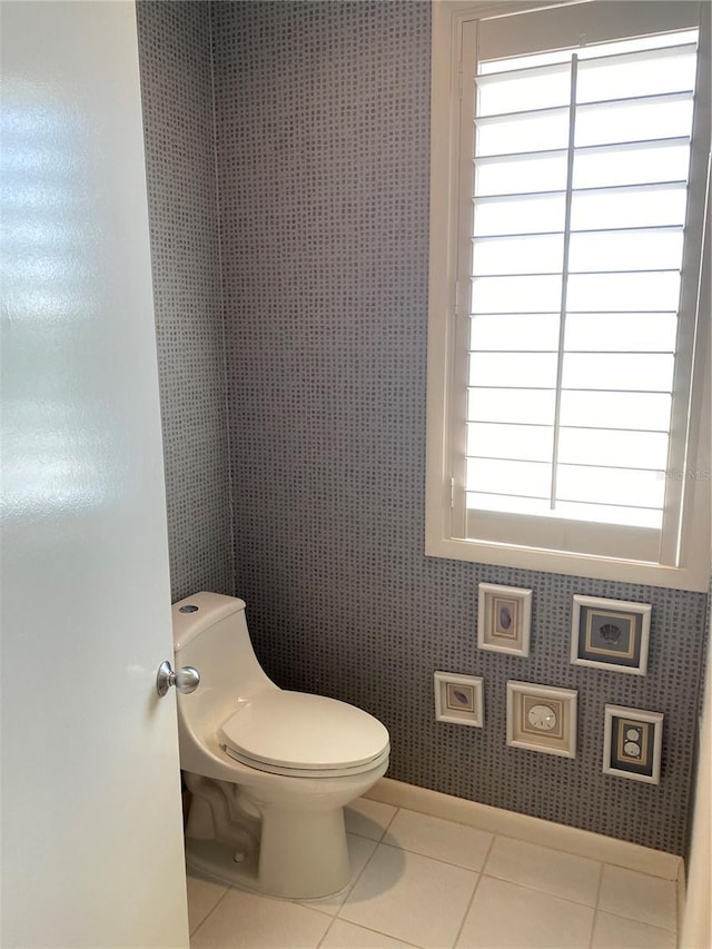 bathroom with toilet and tile patterned flooring