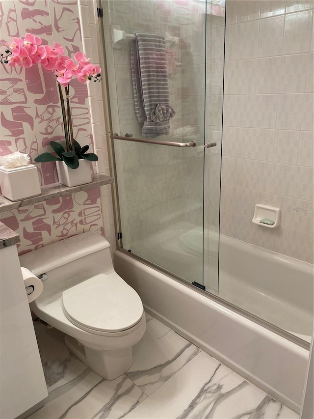 bathroom featuring enclosed tub / shower combo and toilet