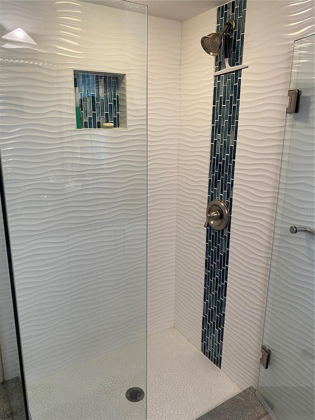 bathroom featuring a shower with door