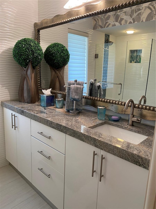 kitchen featuring white cabinetry and sink