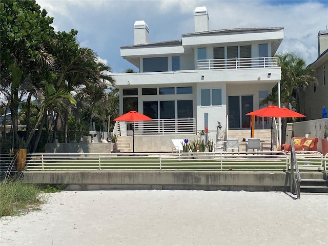 rear view of property with a balcony