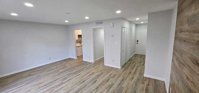 unfurnished room with light hardwood / wood-style floors