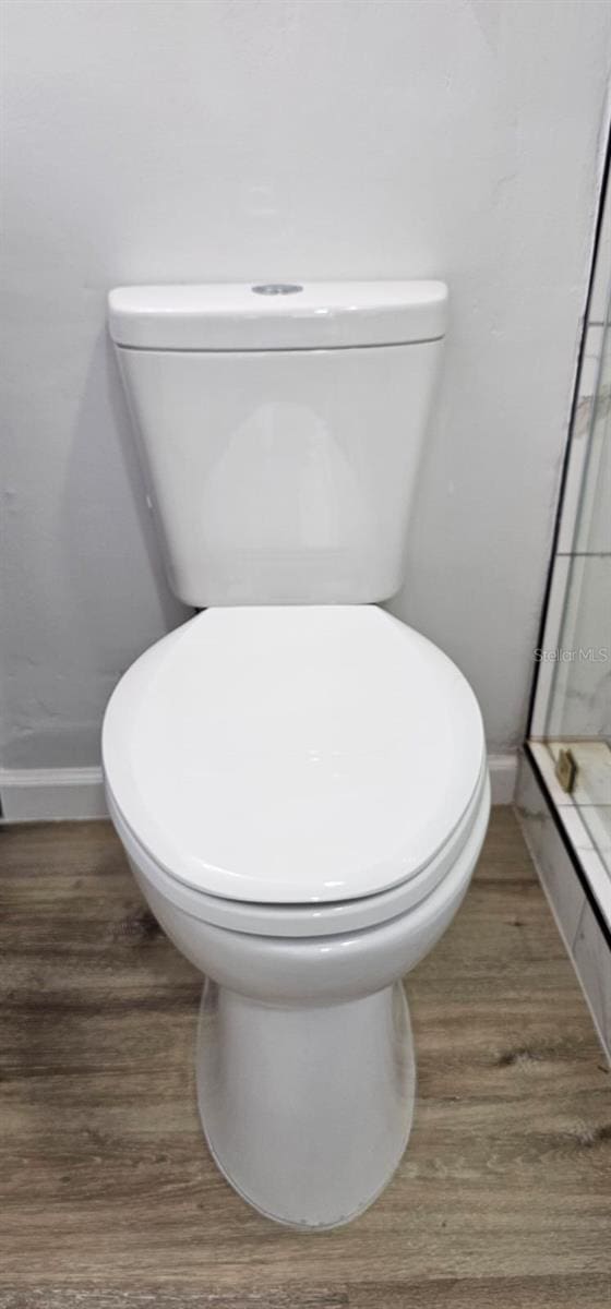 bathroom featuring hardwood / wood-style floors and toilet