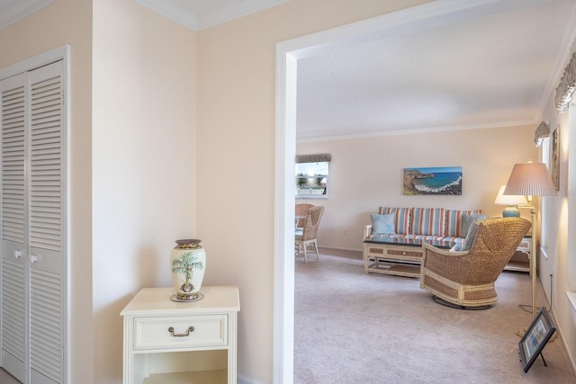 living area with crown molding and carpet