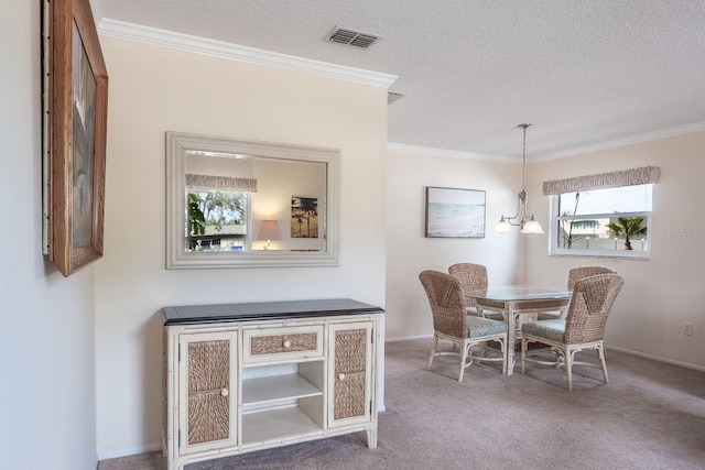 dining room with ornamental molding, carpet floors, and a textured ceiling