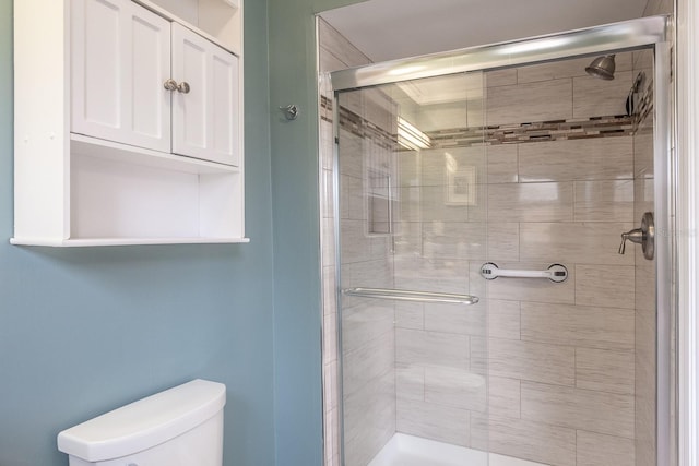 bathroom featuring an enclosed shower and toilet