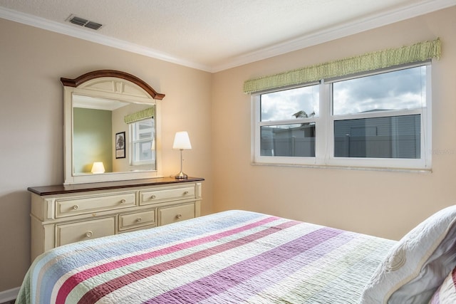 bedroom with crown molding and a textured ceiling