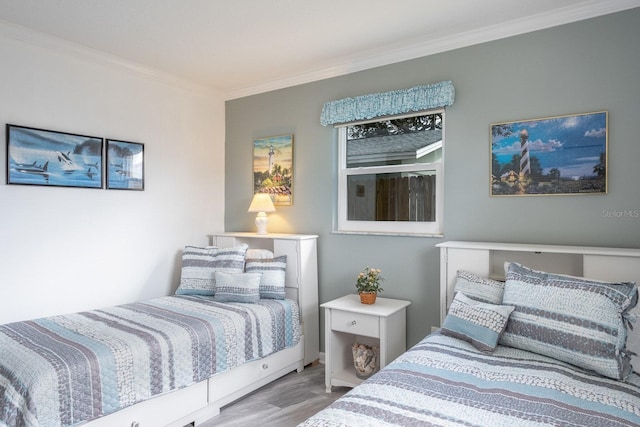 bedroom featuring crown molding and light wood-type flooring