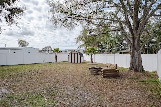 view of yard featuring a storage shed and a fire pit