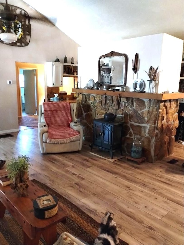 sitting room featuring light hardwood / wood-style flooring and a wood stove