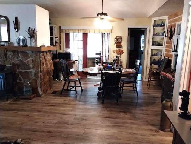 dining area featuring ceiling fan, lofted ceiling, and dark hardwood / wood-style flooring