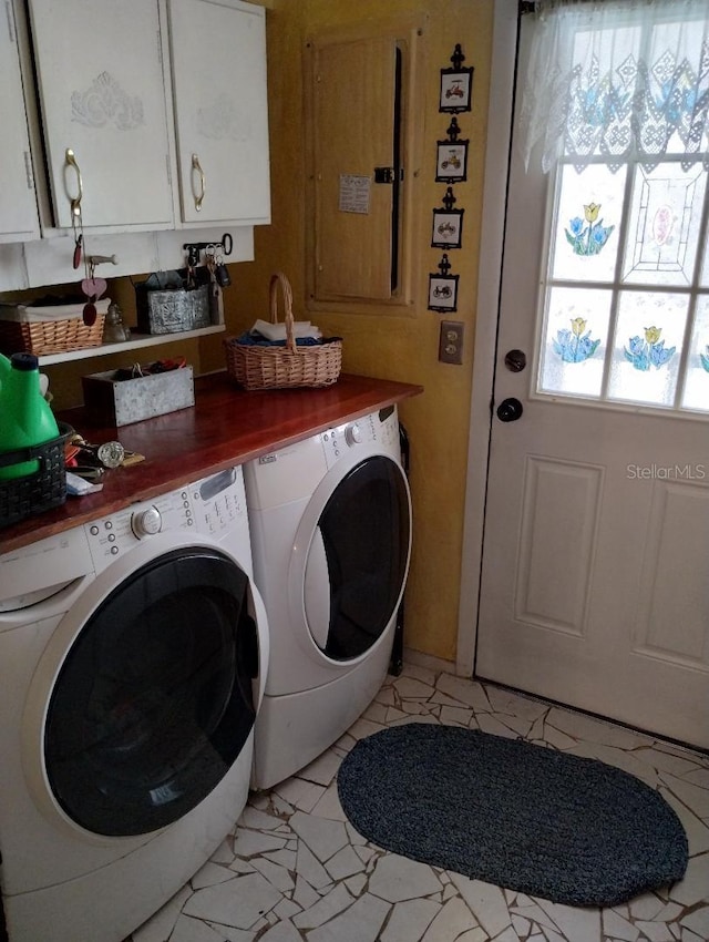 laundry room with cabinets and washing machine and clothes dryer