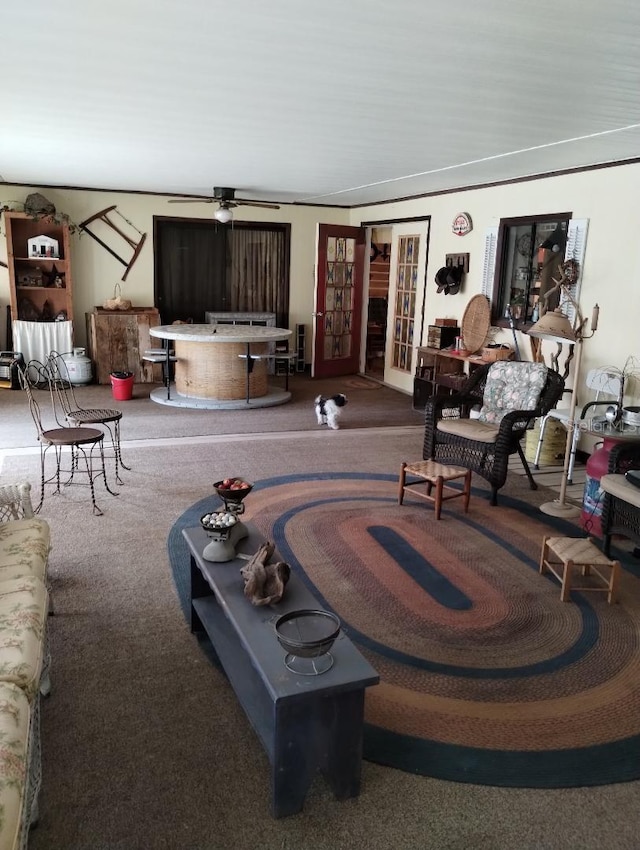 carpeted living room with french doors and ceiling fan