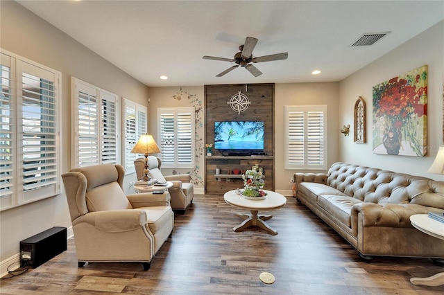 living room featuring baseboards, visible vents, a ceiling fan, dark wood-style floors, and recessed lighting