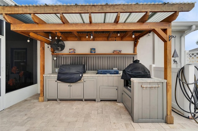 view of patio with area for grilling and outdoor wet bar