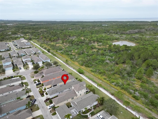 bird's eye view featuring a residential view, a water view, and a view of trees