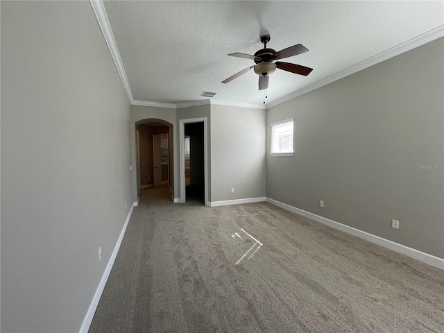 spare room with crown molding, ceiling fan, carpet flooring, and a textured ceiling