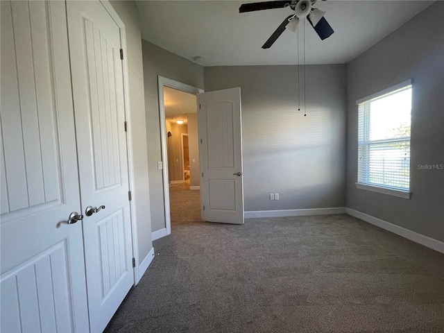 unfurnished bedroom with ceiling fan and carpet